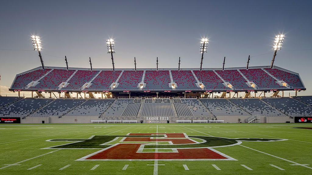 A football stadium with a field and a field with a crowd of people.