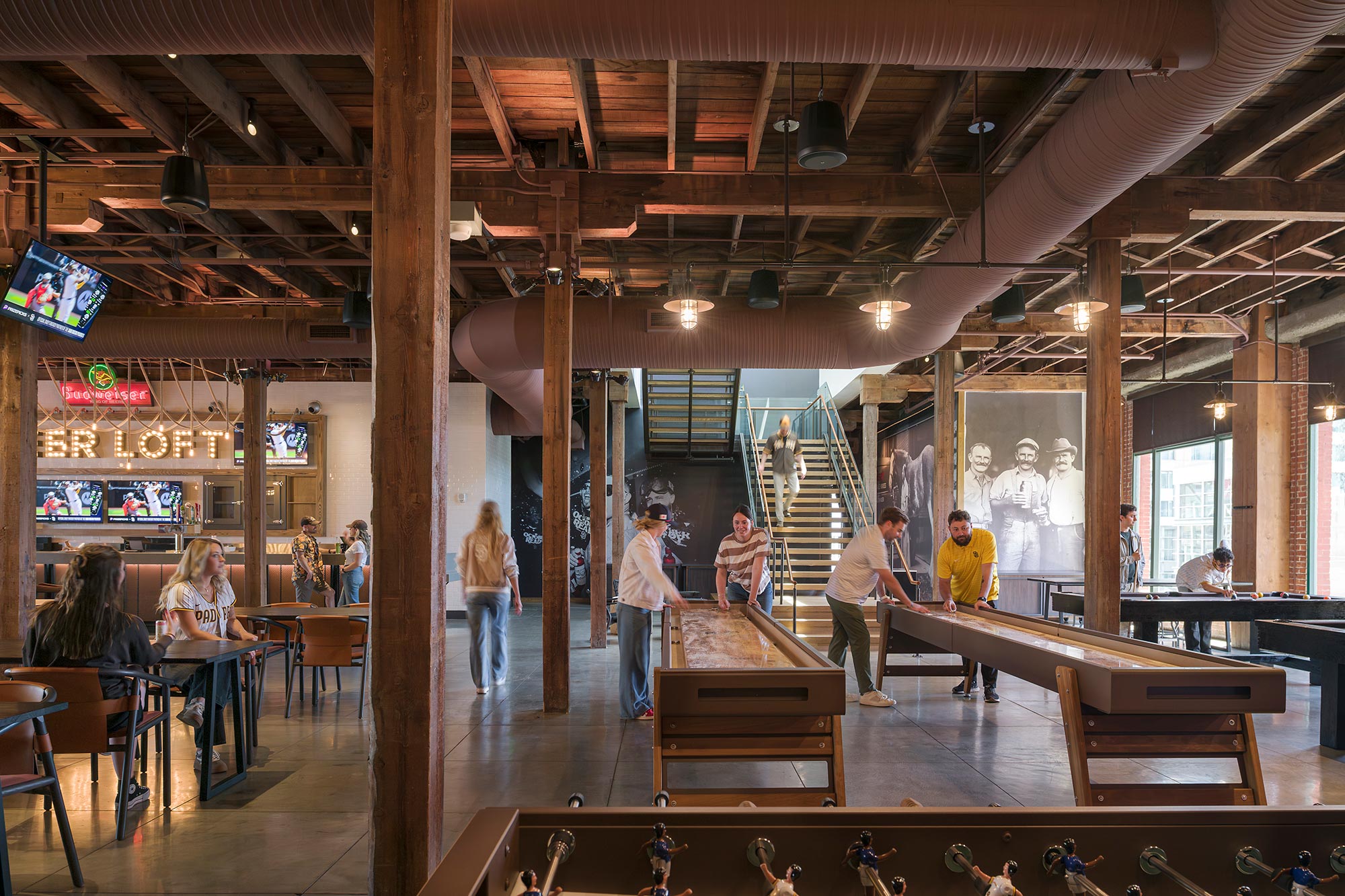 People in a room with tables and chairs.