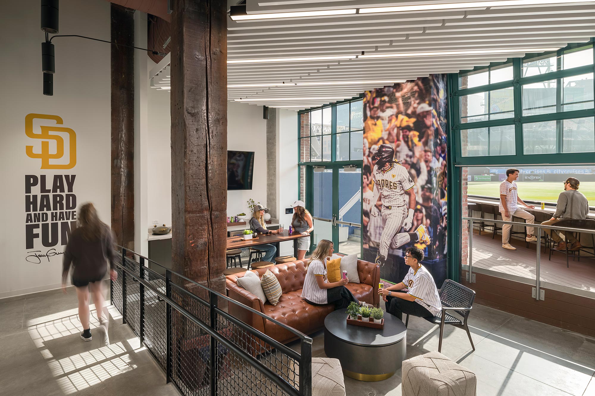 A group of people sitting in a room with a large window.