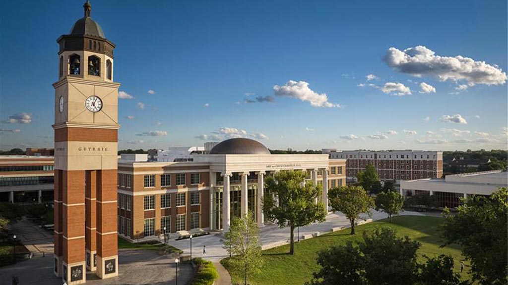 A clock tower in front of a building.