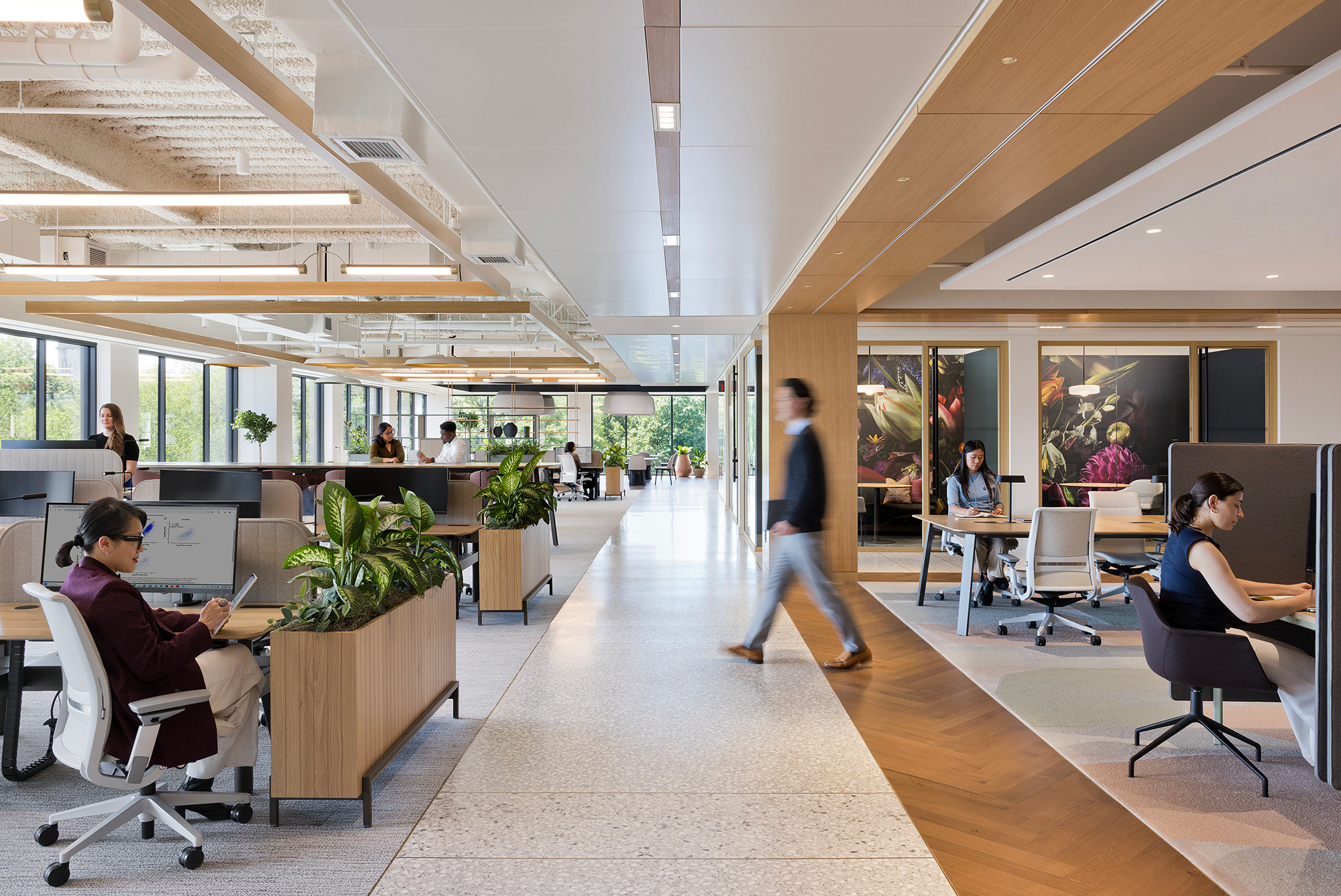 A person walking in a large office.