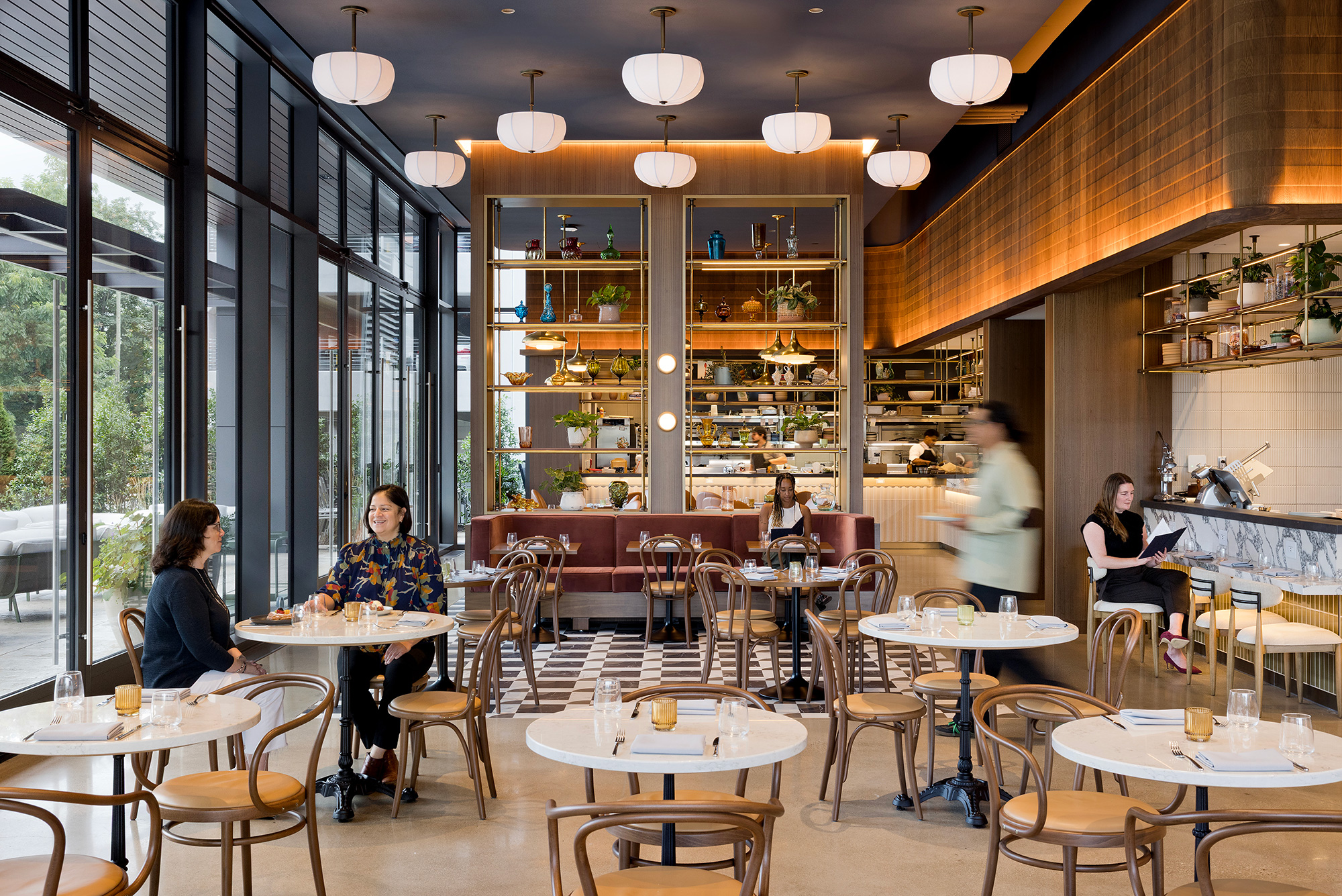 People sitting at tables in a restaurant.