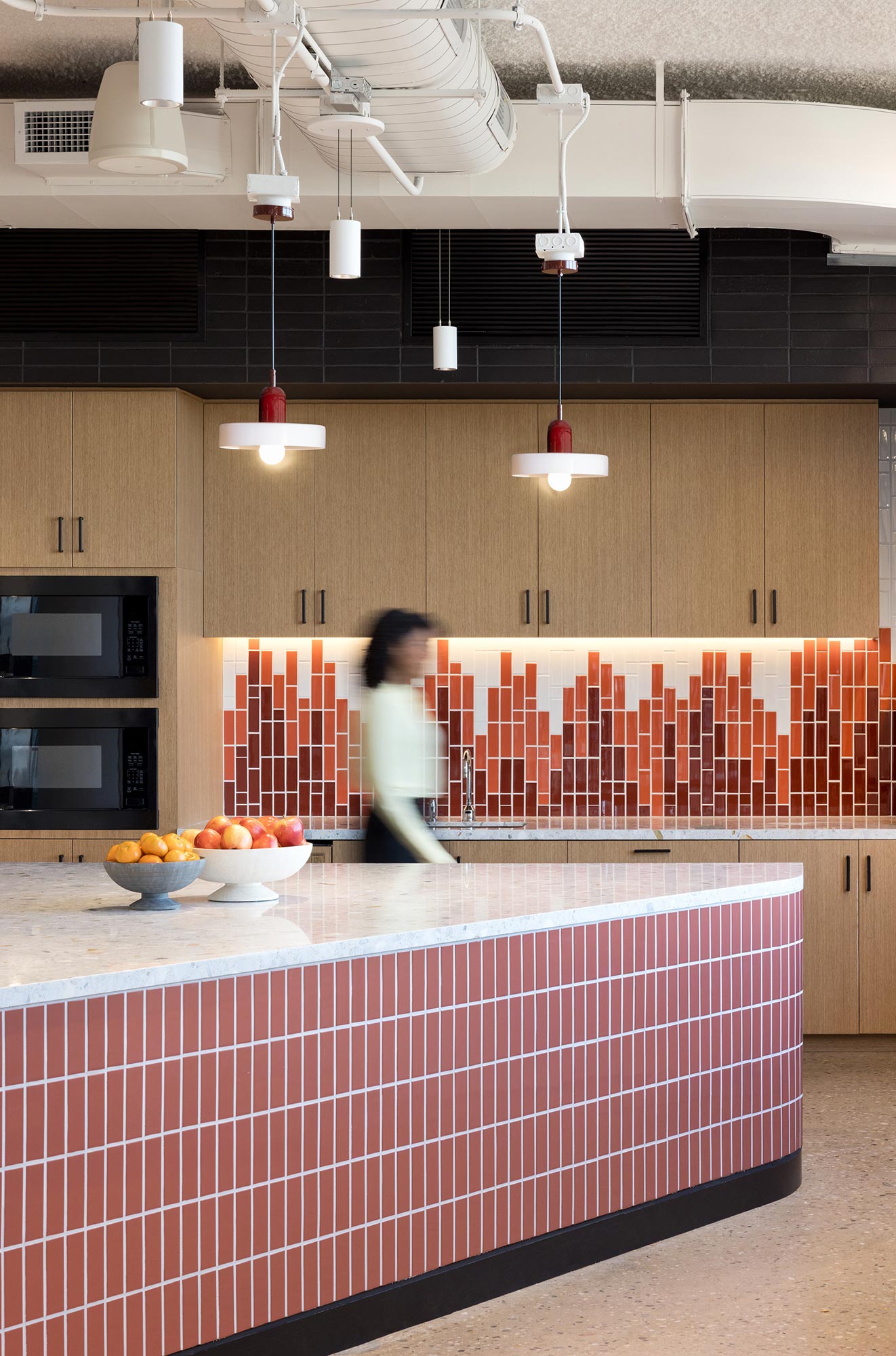 A person walking in a kitchen.