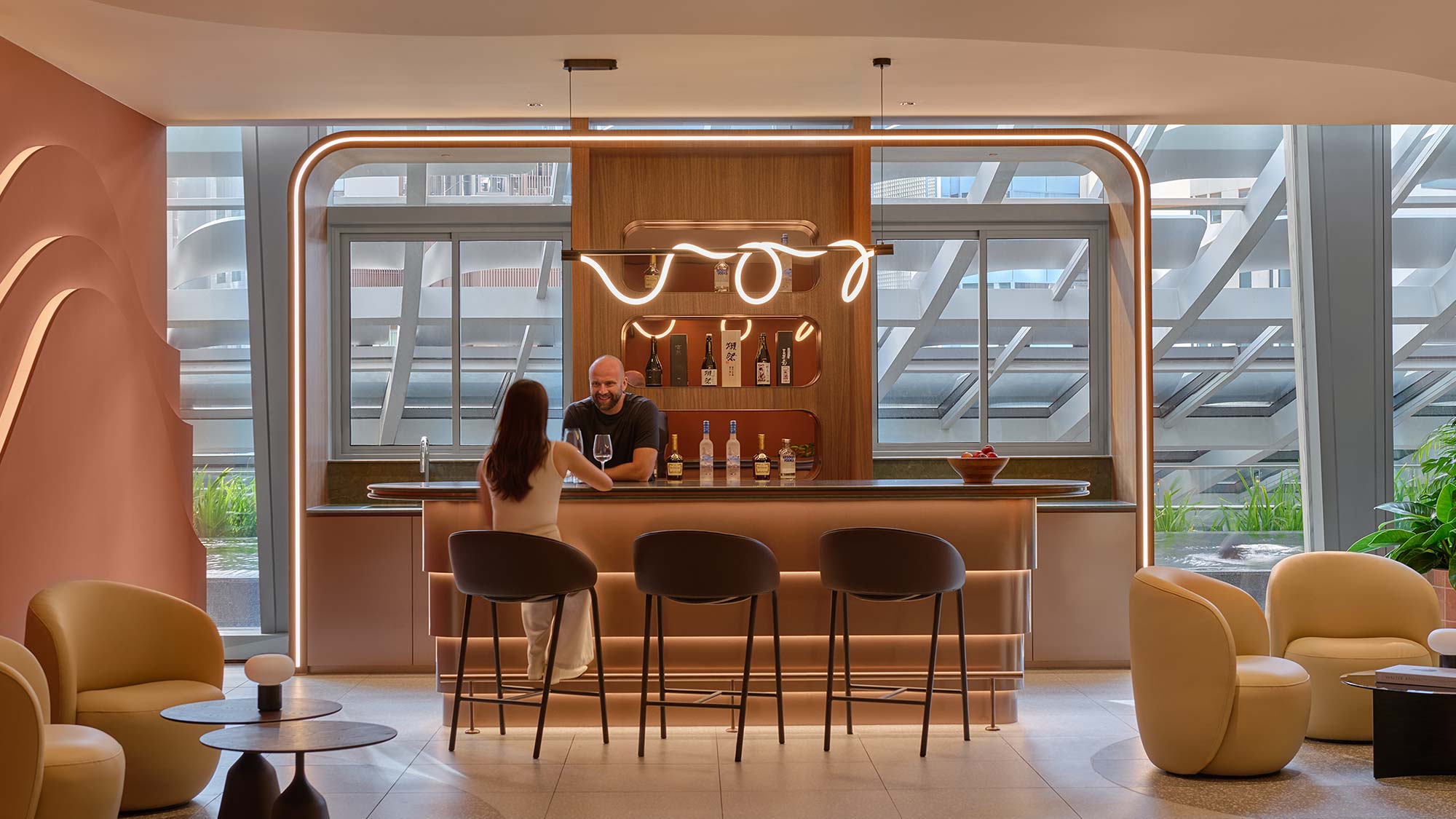 A man and woman sitting at a bar.