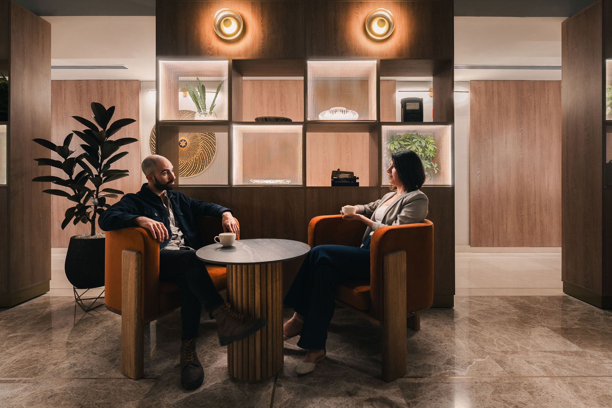 A man and a woman sitting in chairs in a room.