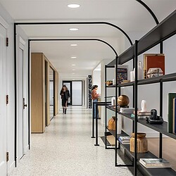 A room with shelves and a bookcase.