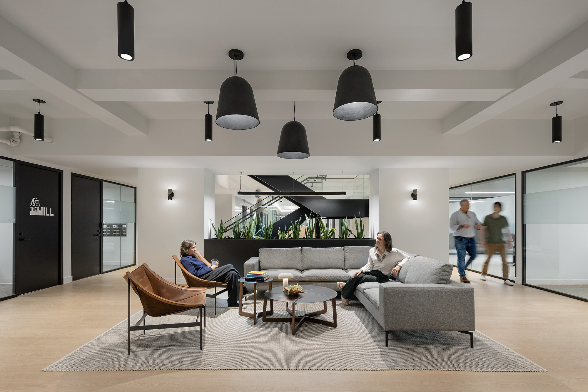 A group of people in a room with a couch and a table.