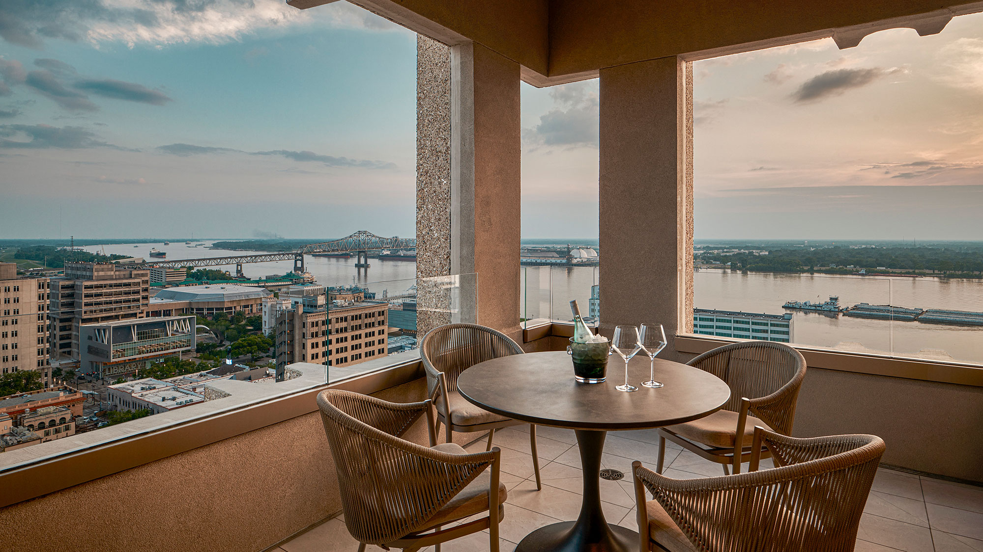 A table and chairs on a balcony.