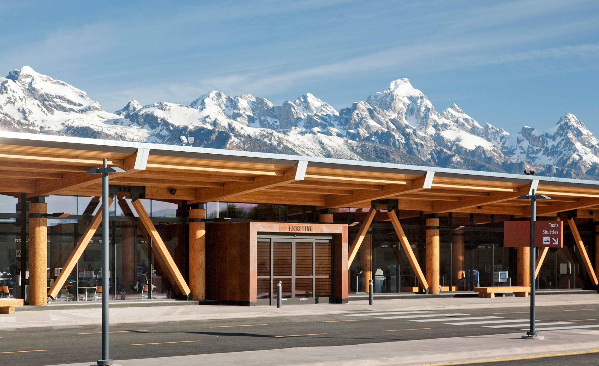 A building with snow covered mountains in the background.
