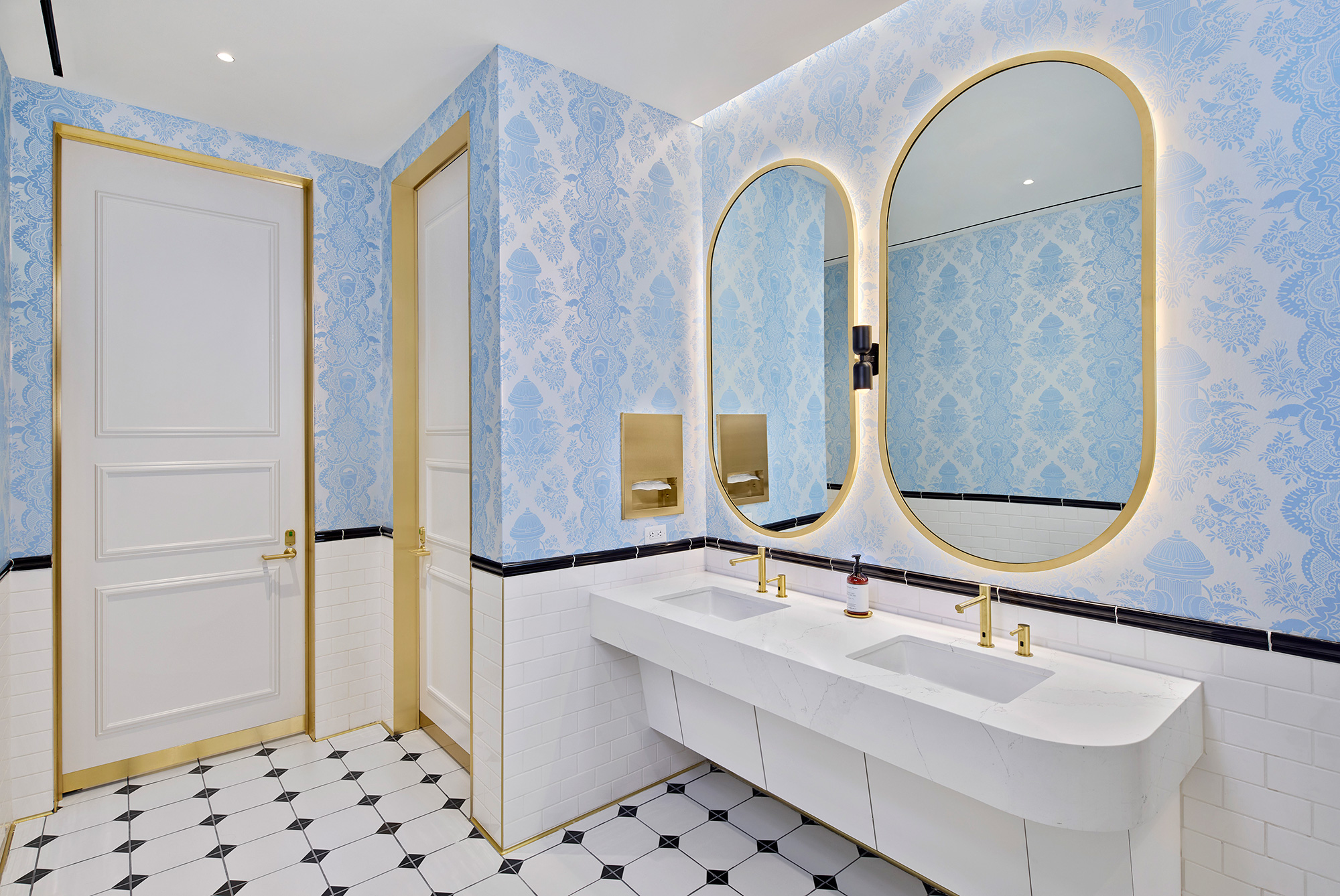 A bathroom with a large mirror.