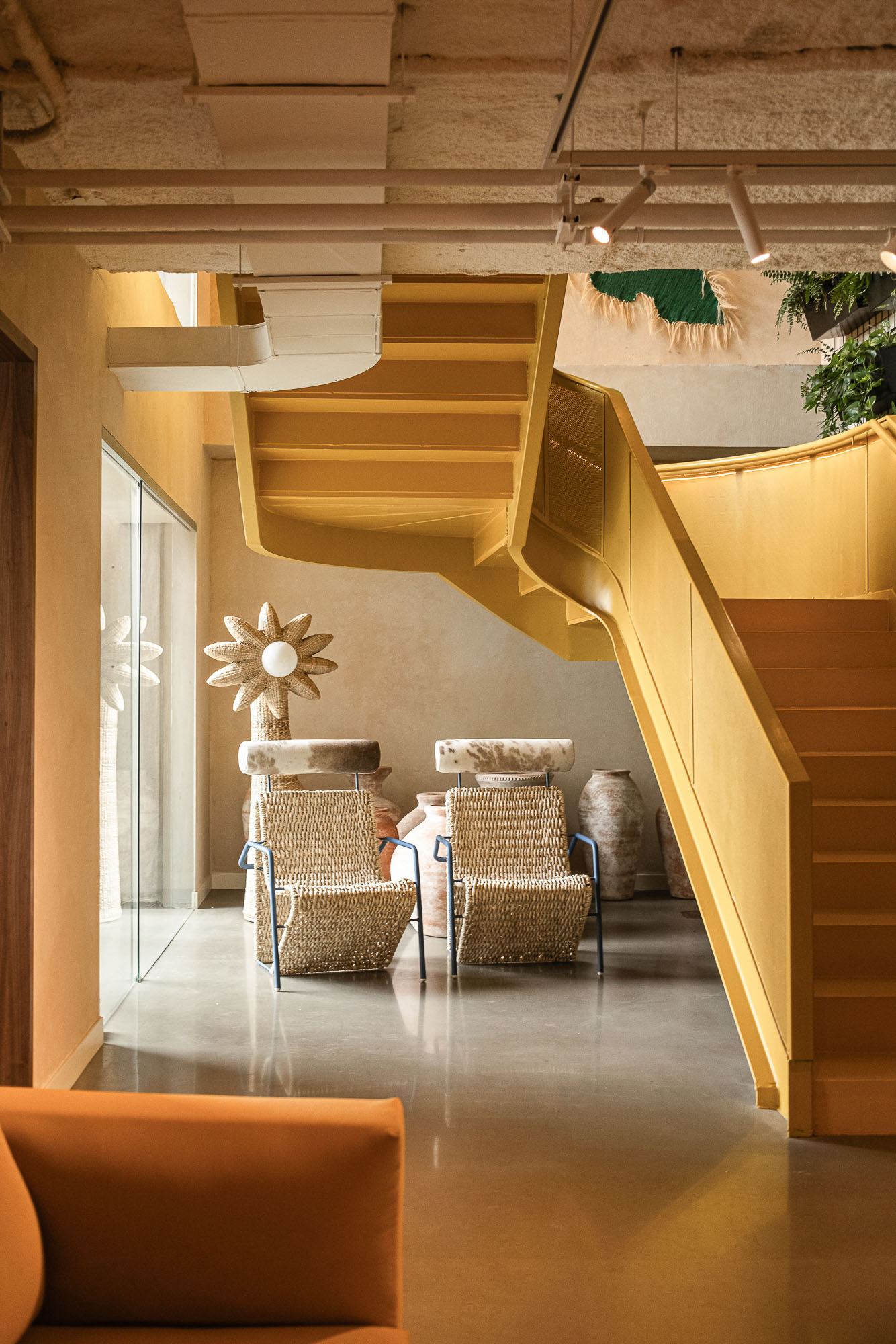 A staircase with chairs and a table.