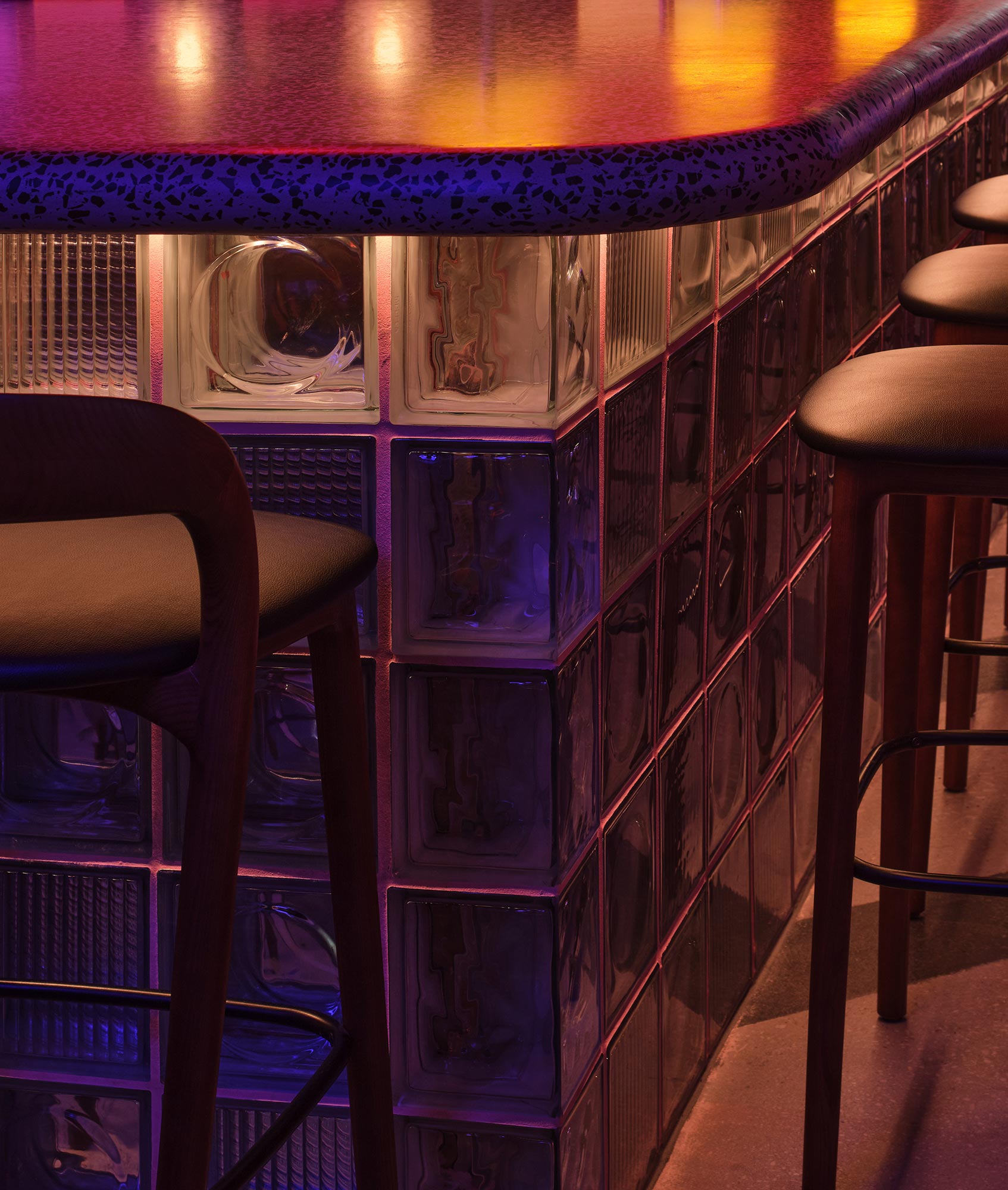 A row of blue and purple shelves.