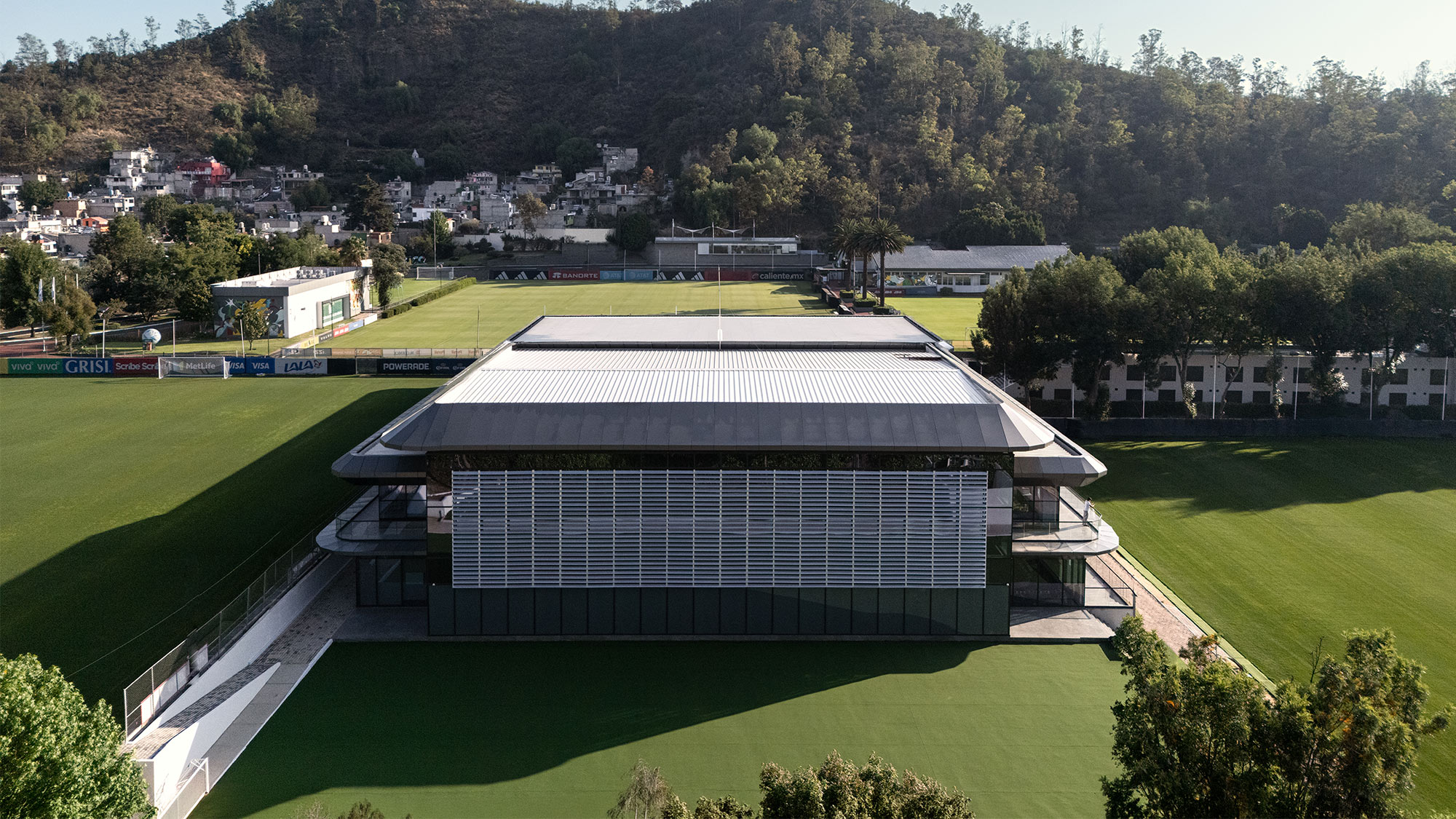 A building with a field in the front.