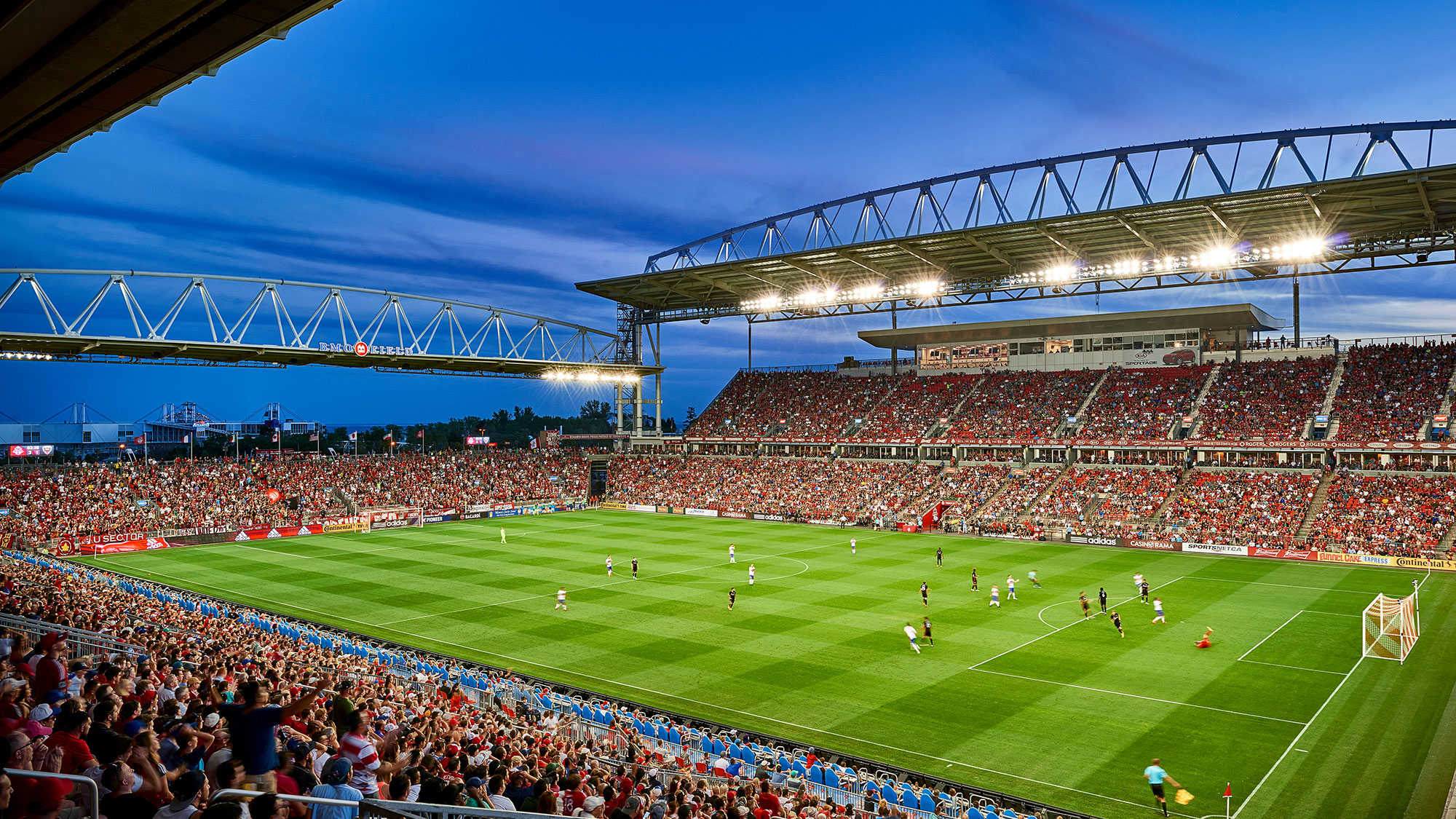 A football stadium with a field and players on it.