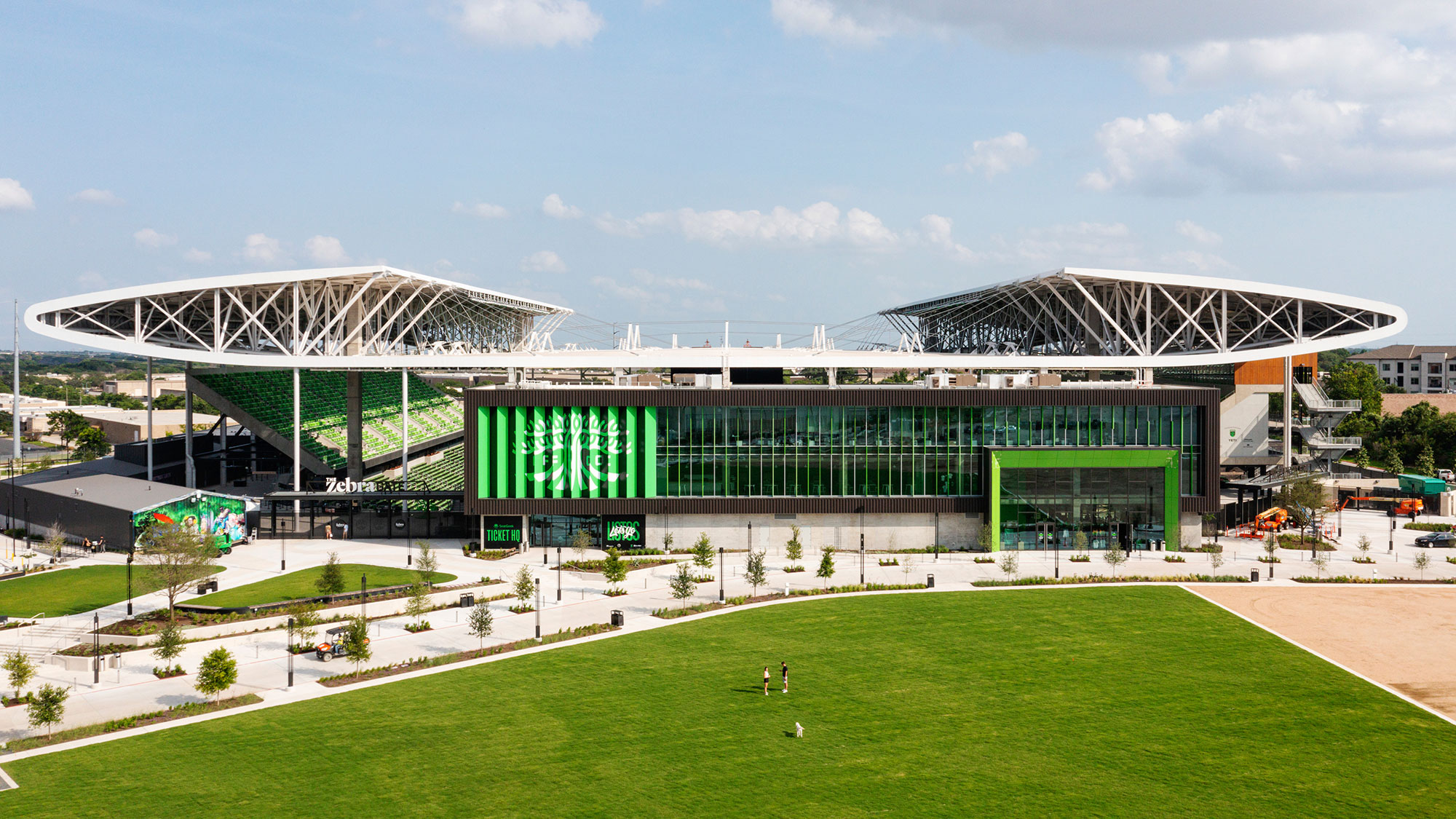 A large stadium with a green field.