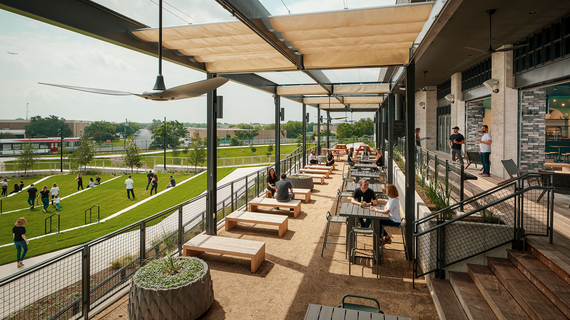 People sitting at tables outside.