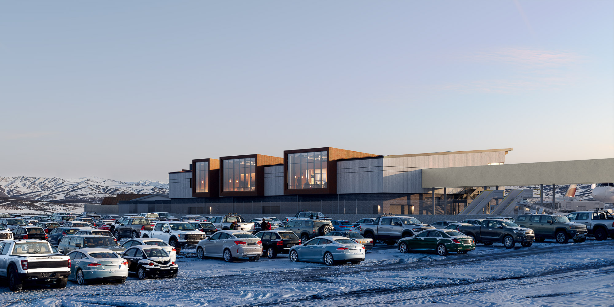 A parking lot with cars and a building in the background.