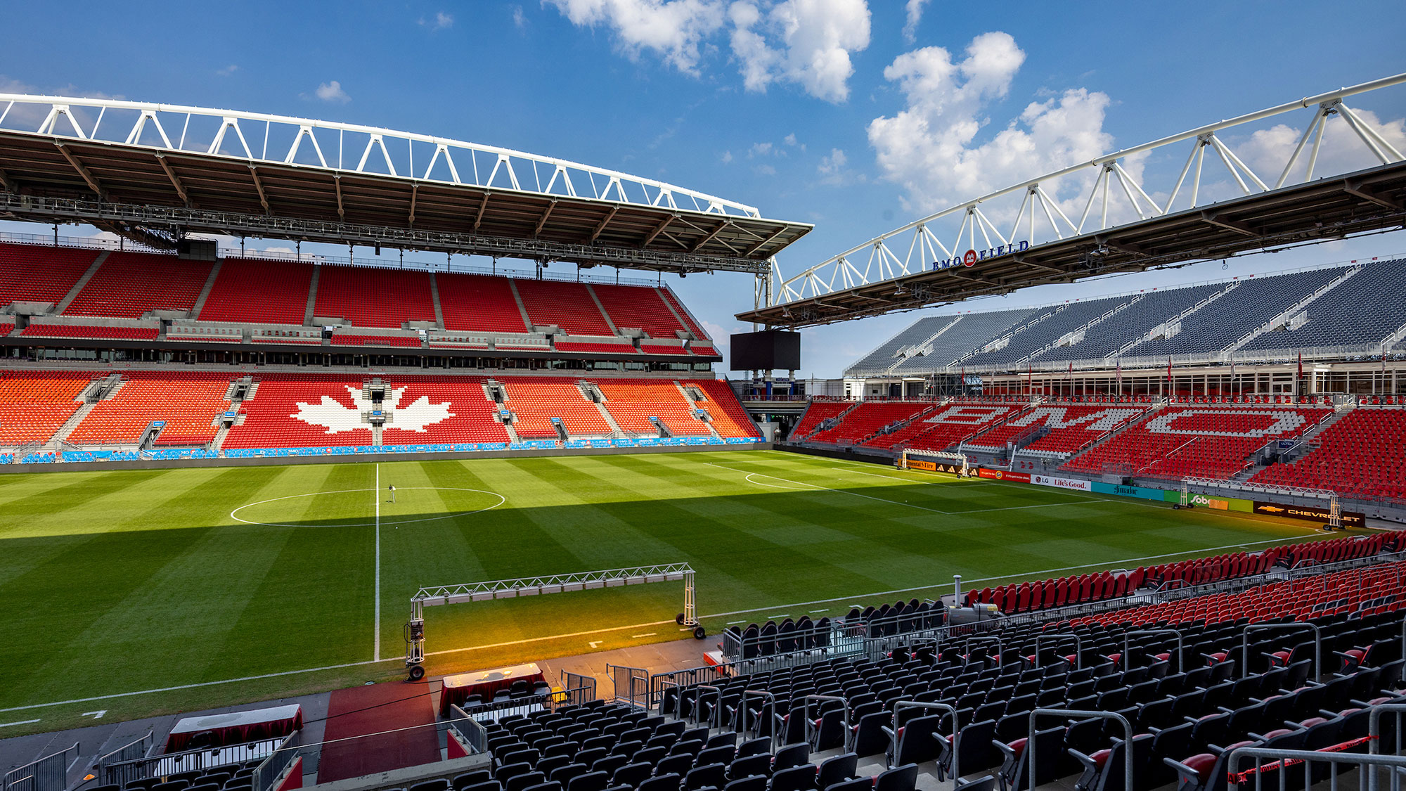 A sports stadium with a field and seating.