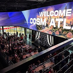 A large crowd of people at a convention.