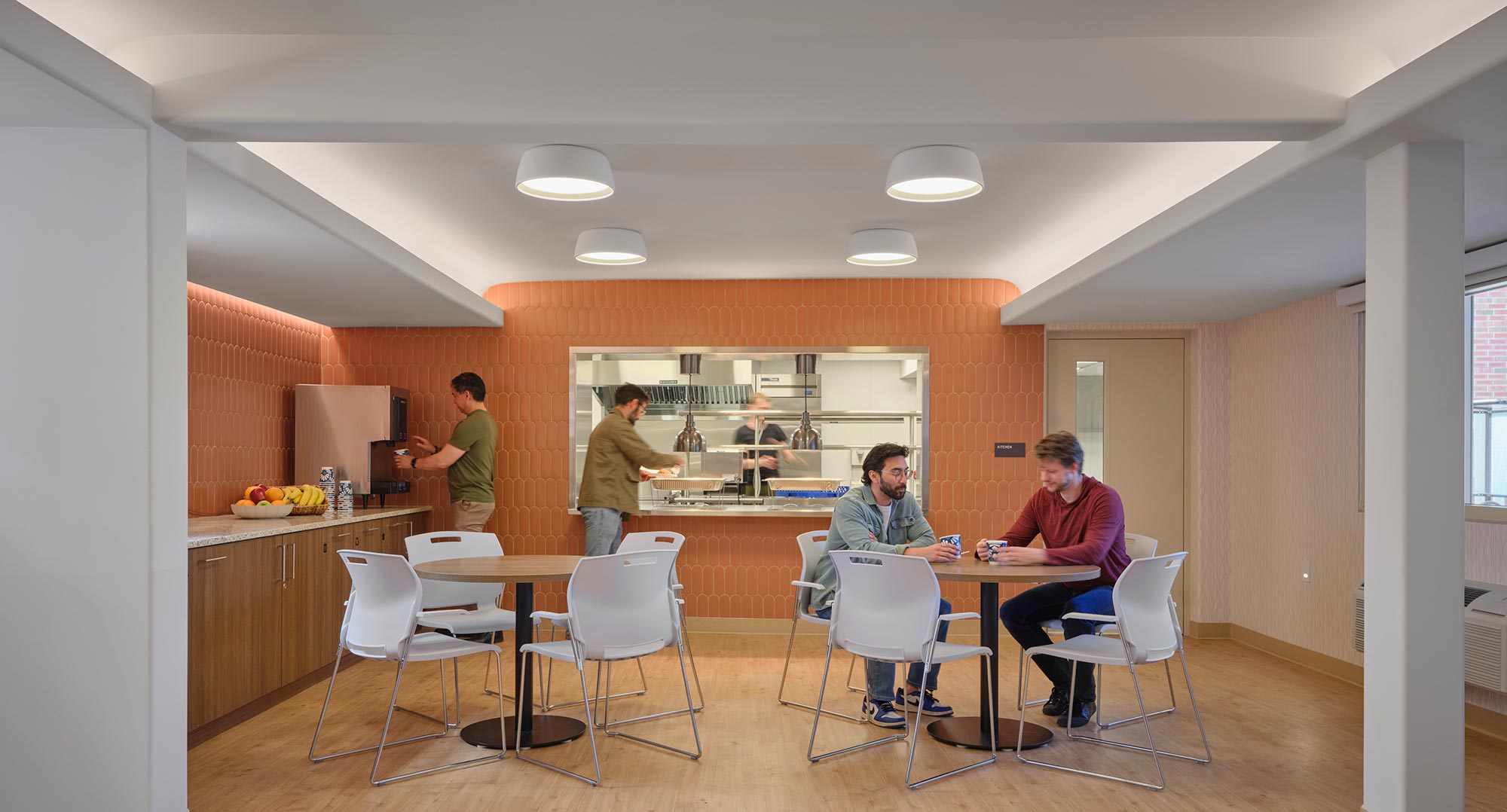 A group of people in a kitchen.