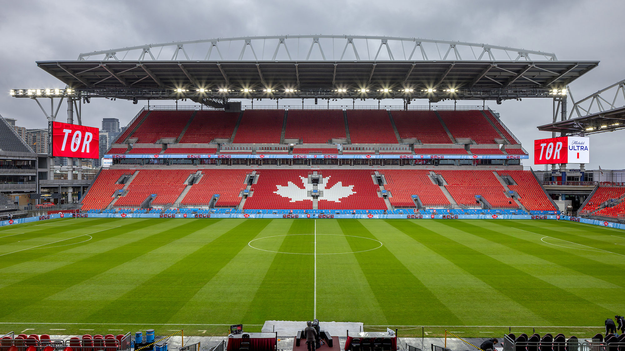 A sports stadium with a field and a field with a large crowd.