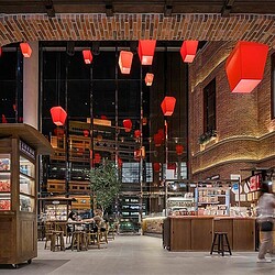 A building with lanterns from the ceiling.
