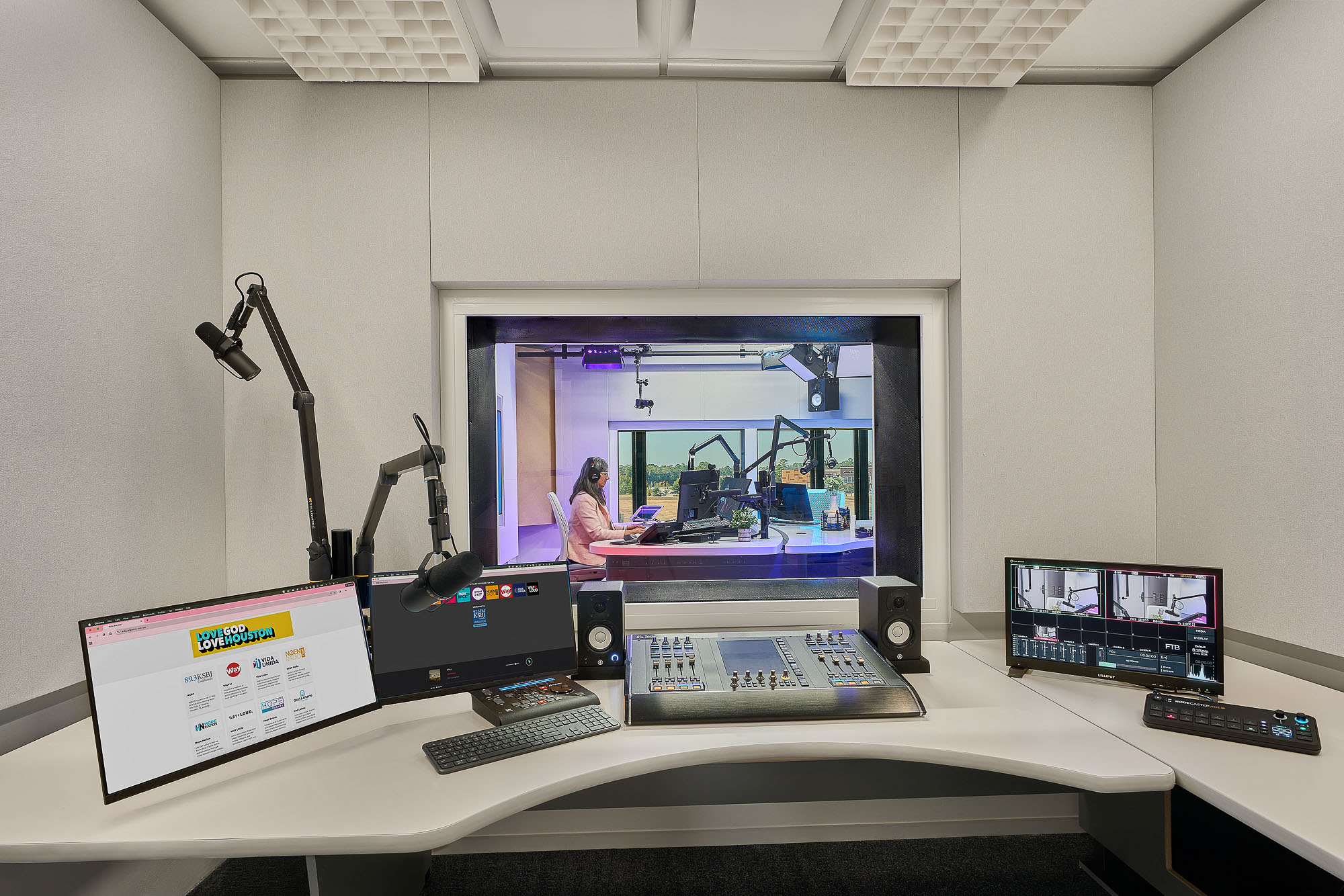A desk with a computer and microphone.