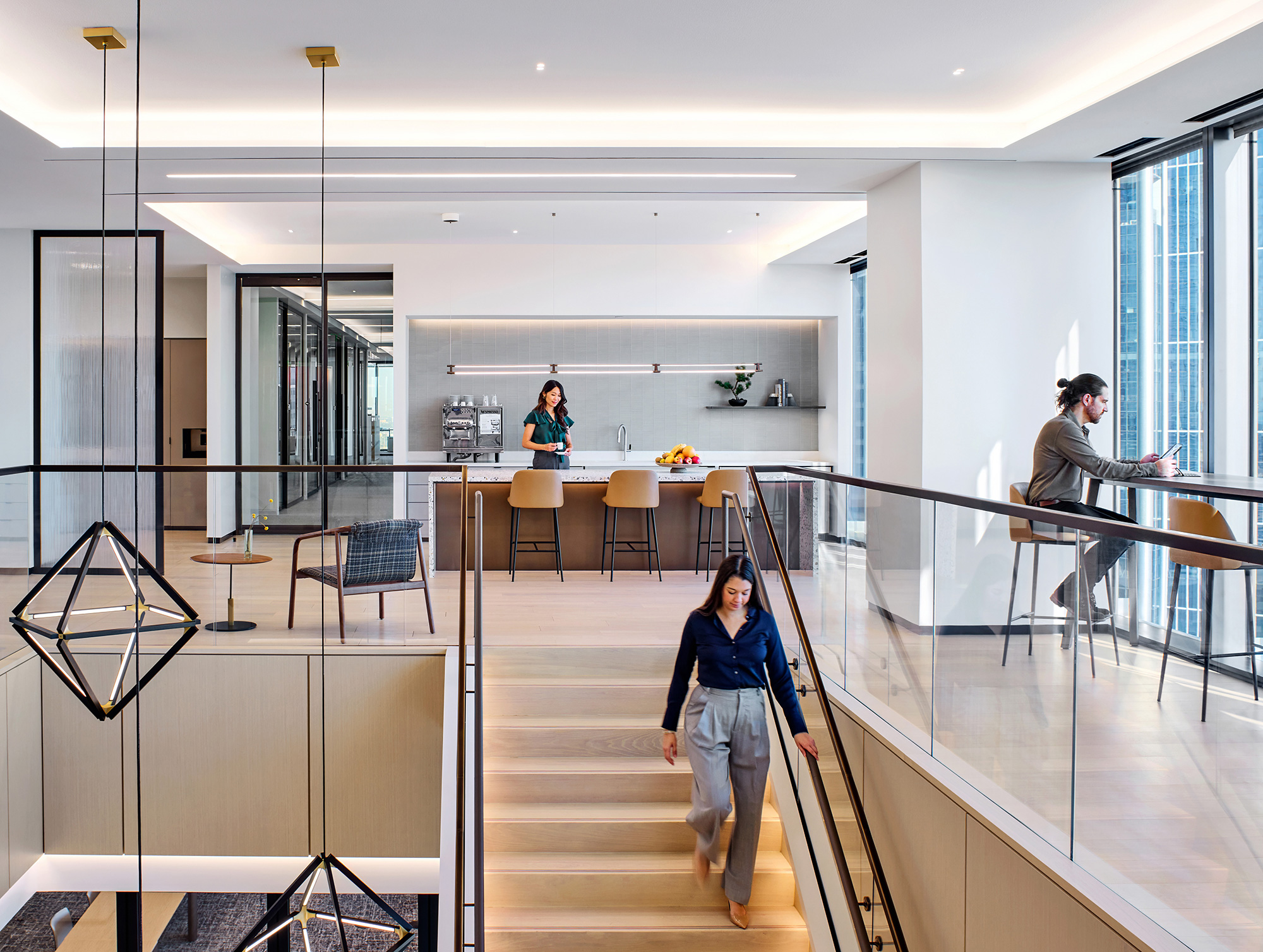 A few people walking in a building.