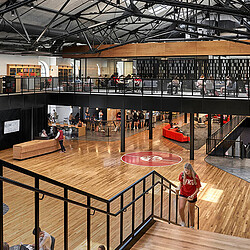 A group of people in a large room with a large circular floor.