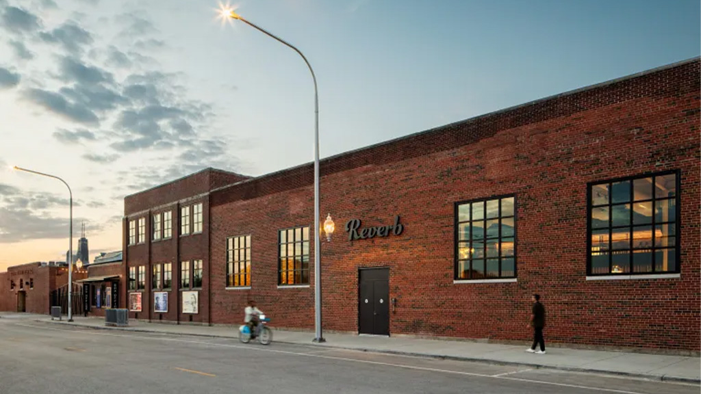 A brick building with a person walking by it.