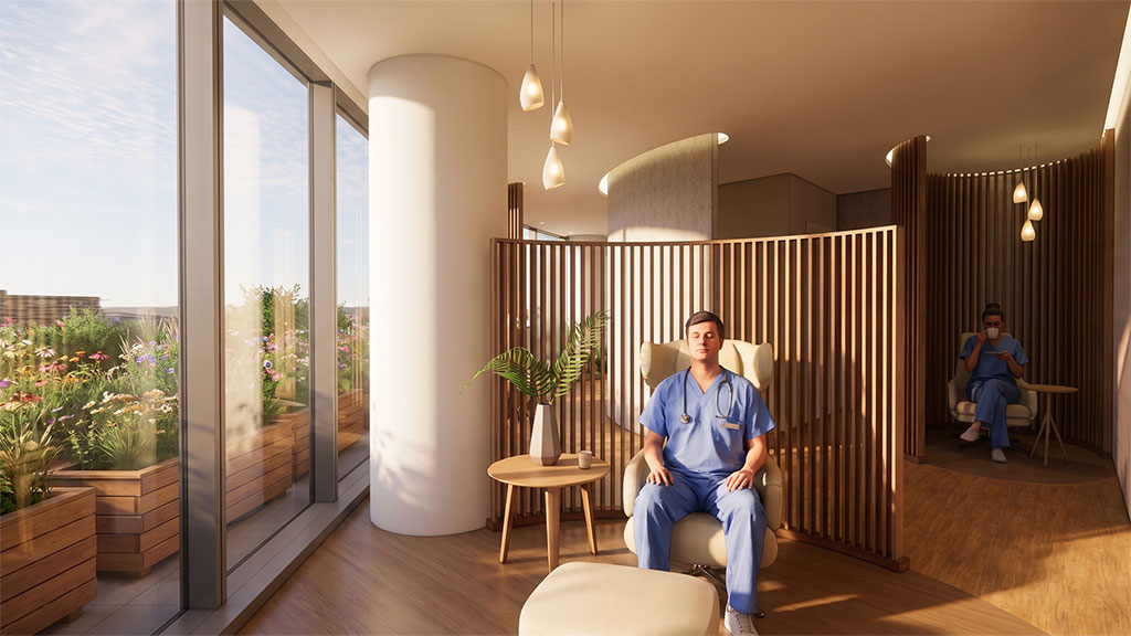 A person sitting on a chair in a room with windows and a railing.