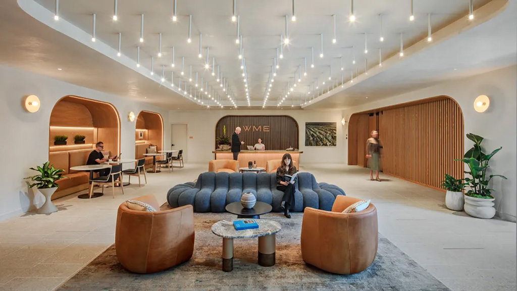 A room with a few people and a couch.