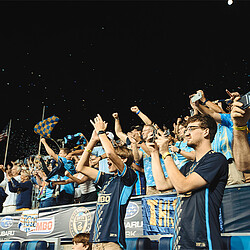 A group of people holding up their hands.