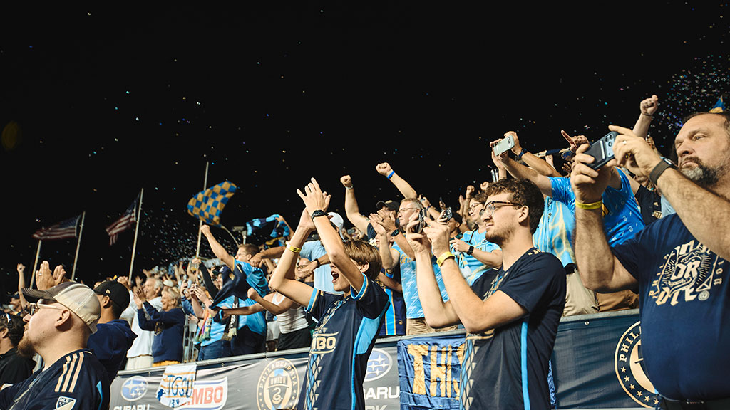 A group of people holding up their hands.