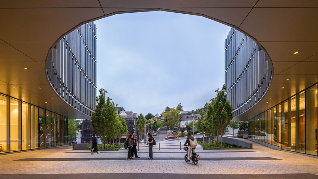 A group of people walking outside a building.