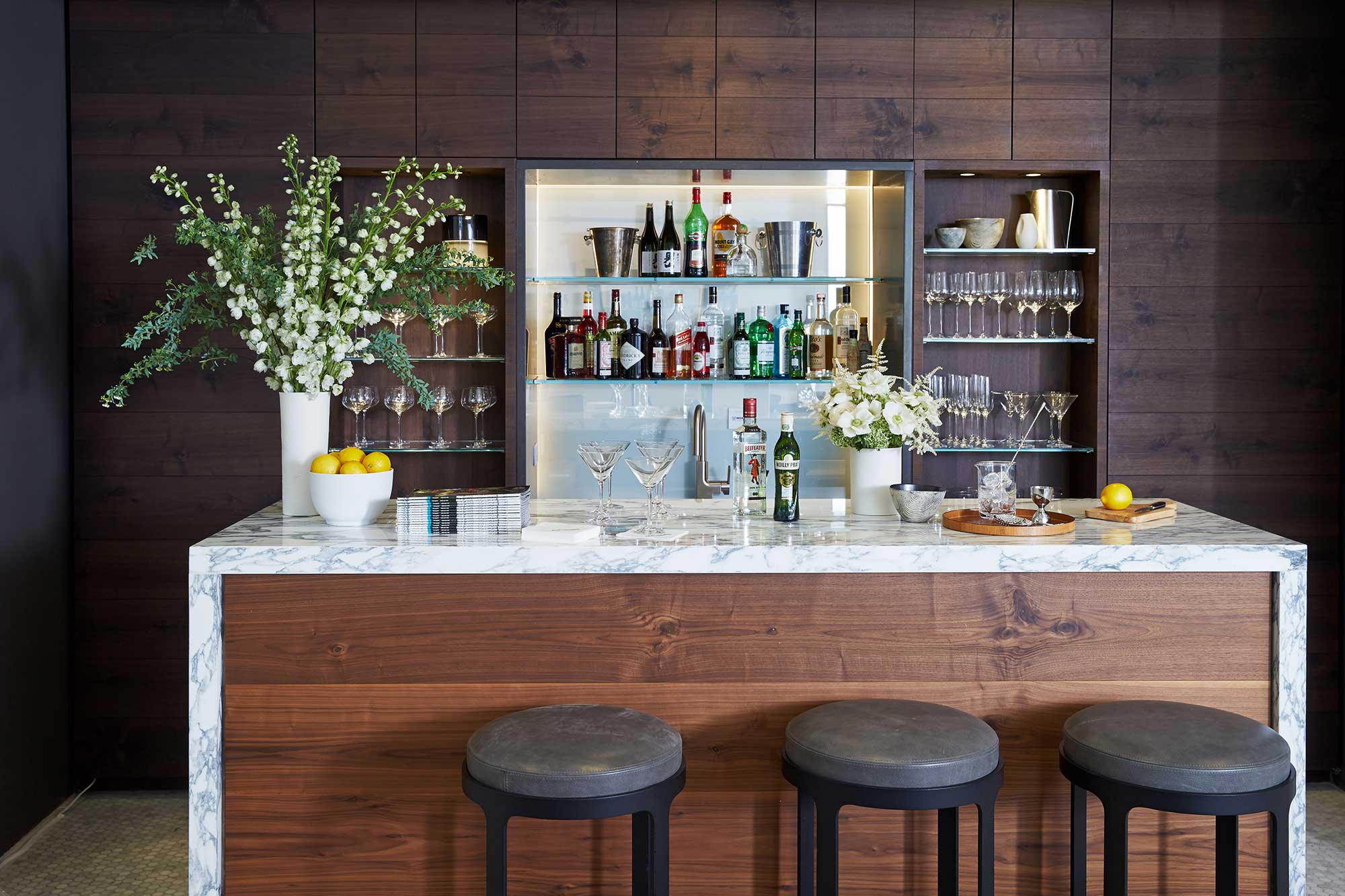 A bar with a counter and stools.