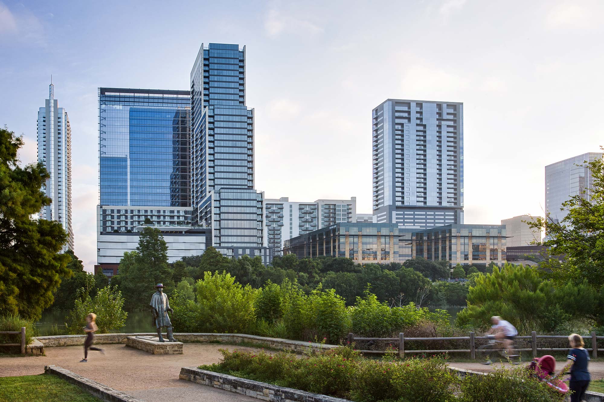 A park with tall buildings in the background.