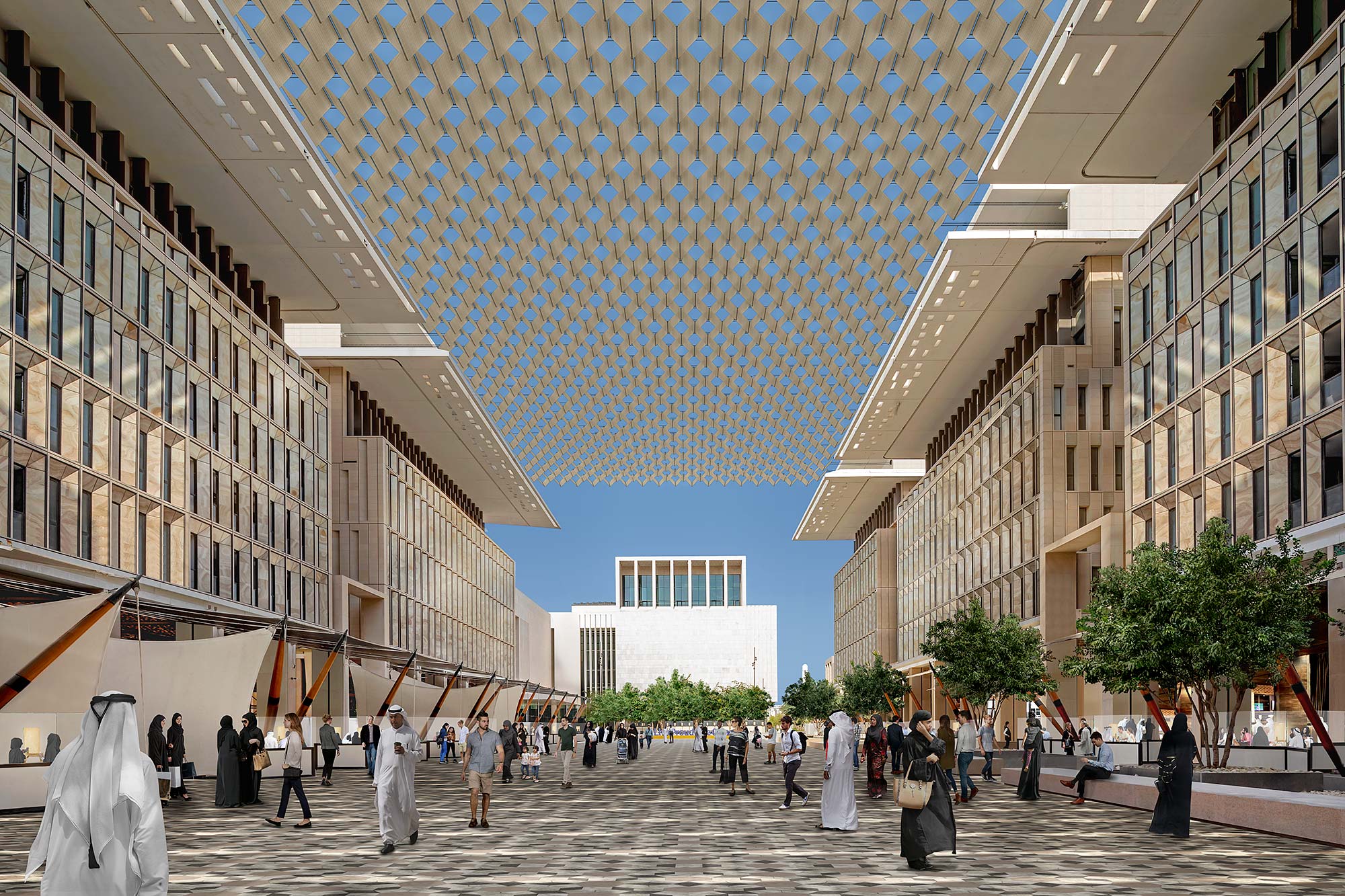 A group of people walking in a large courtyard between buildings.