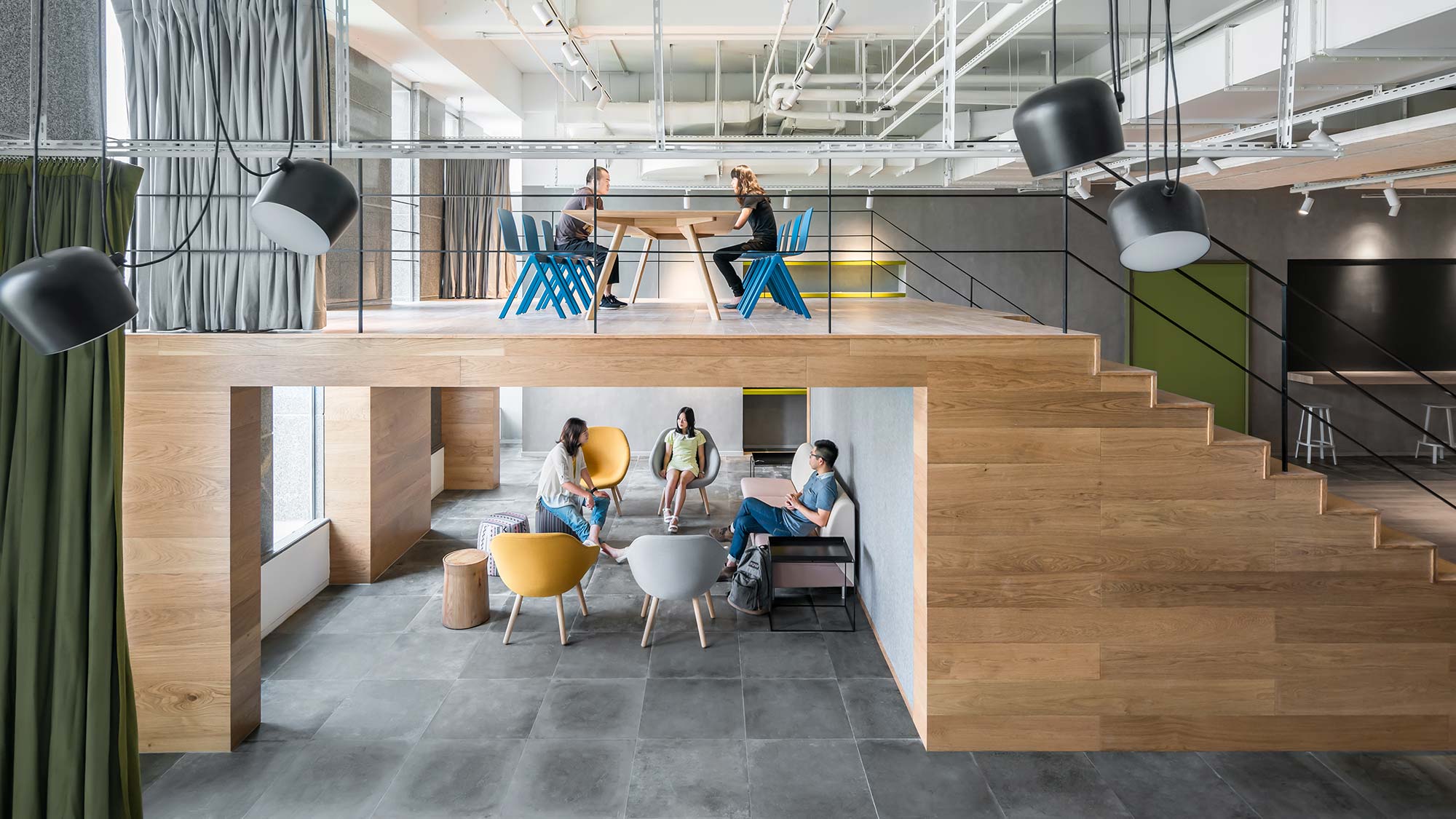 People sitting on chairs in a room.