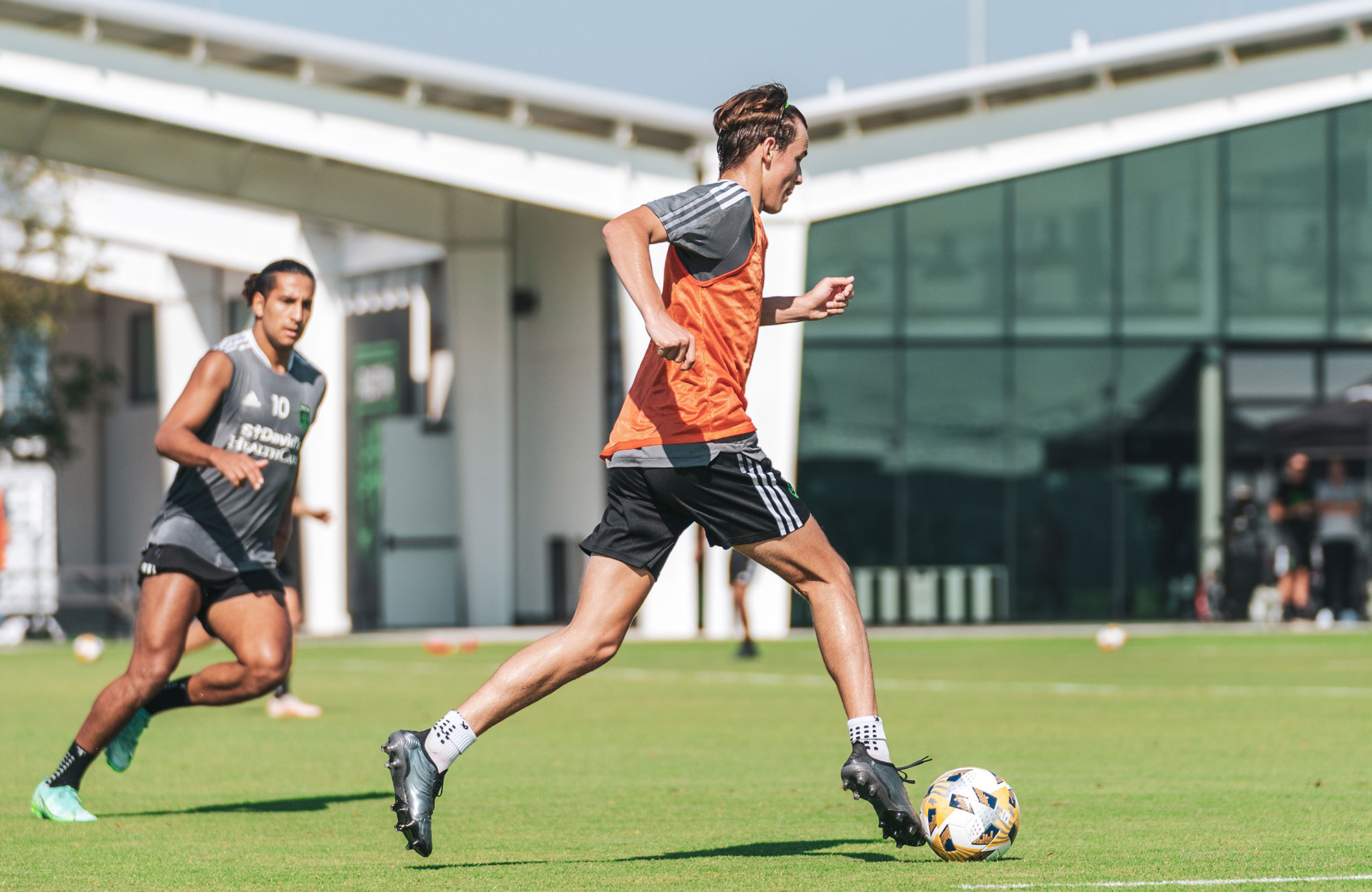 A soccer team practices at an outdoor training facility.