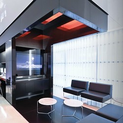 A room with a glass wall and chairs.