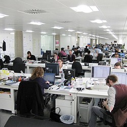 A group of people sitting at computers.
