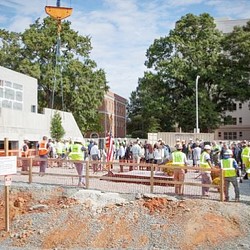 A group of people standing on a construction site.