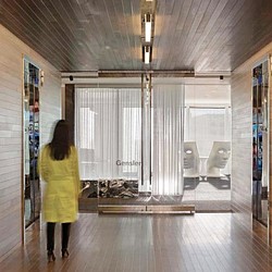 A person looking at a large glass window.