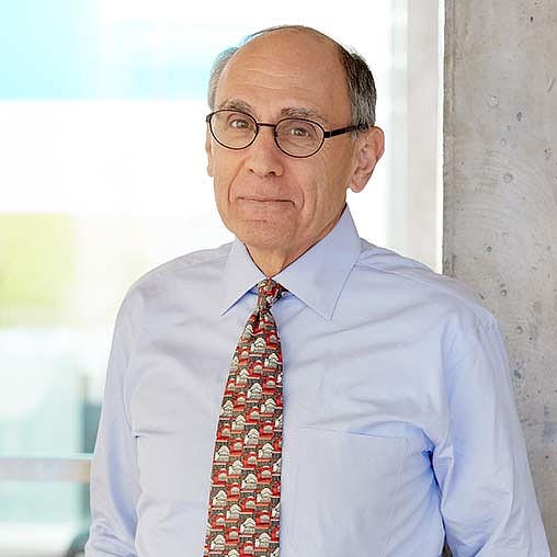A man wearing glasses and a tie.