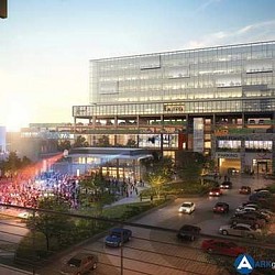 A building with a parking lot and cars in front of it.