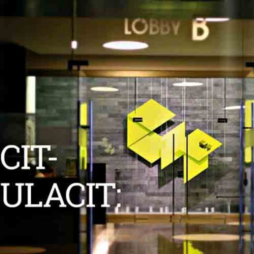 A yellow logo on a glass door.