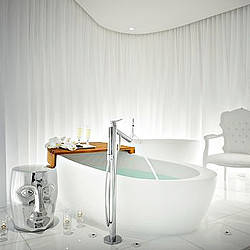 A bathtub with a sink and a chair in the background.