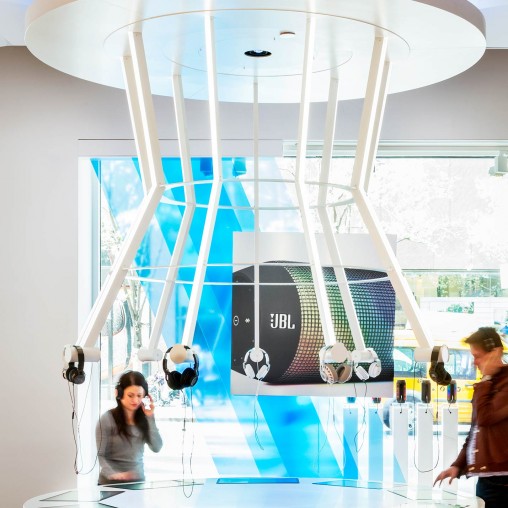 A couple of people in a room with a large glass wall.