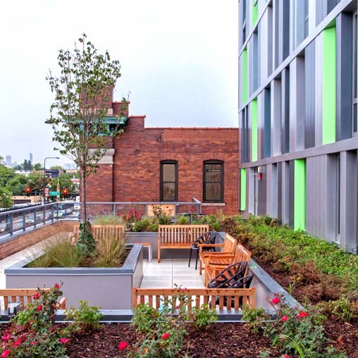 A brick building with a bench and a table in front of it.